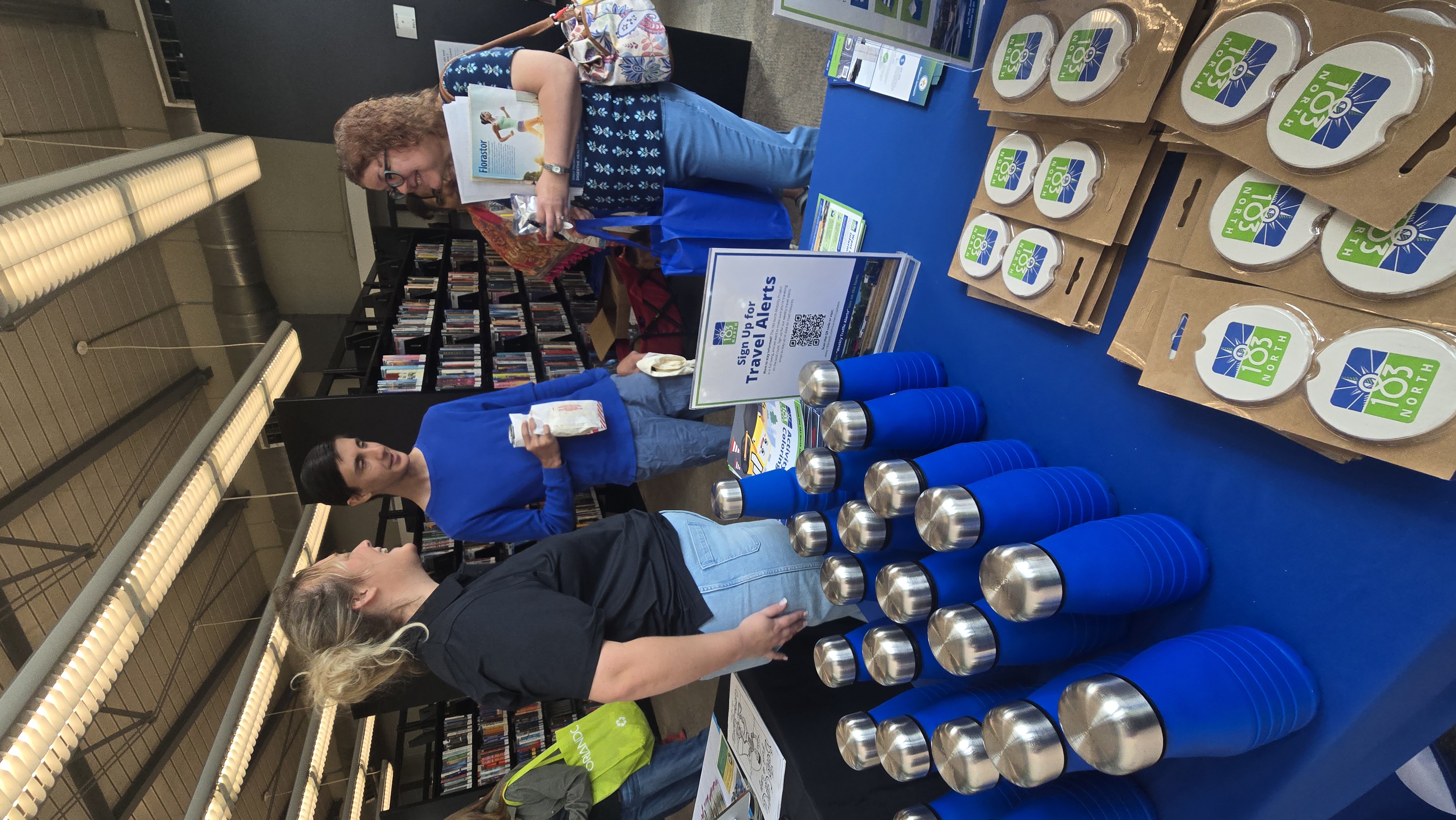 Attendees greet project representative at informational booth