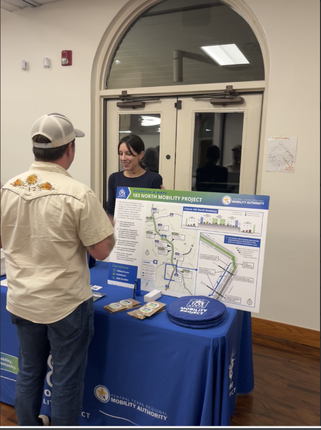 woman speaks to man at info table