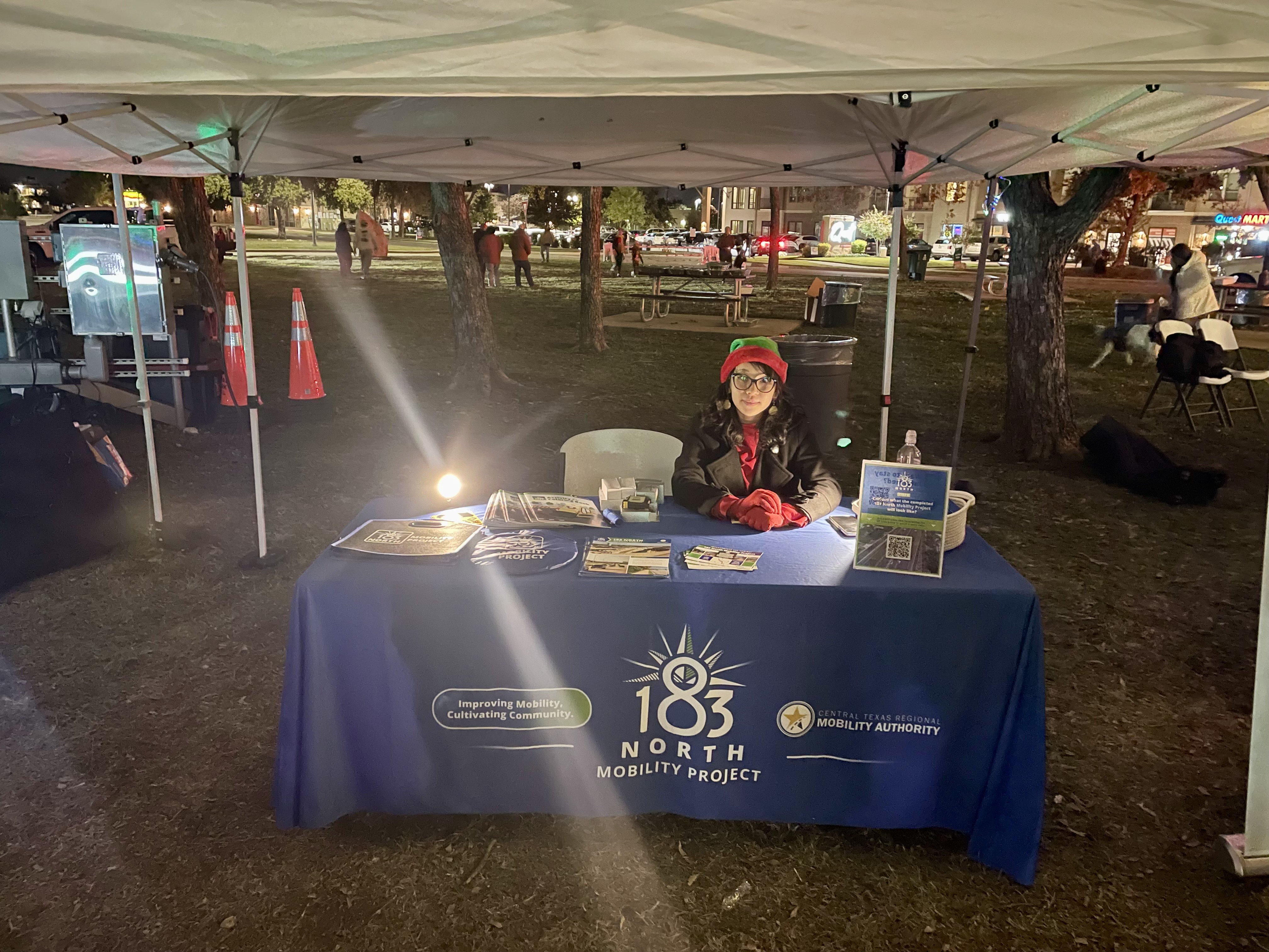 Representative sits at informational table 